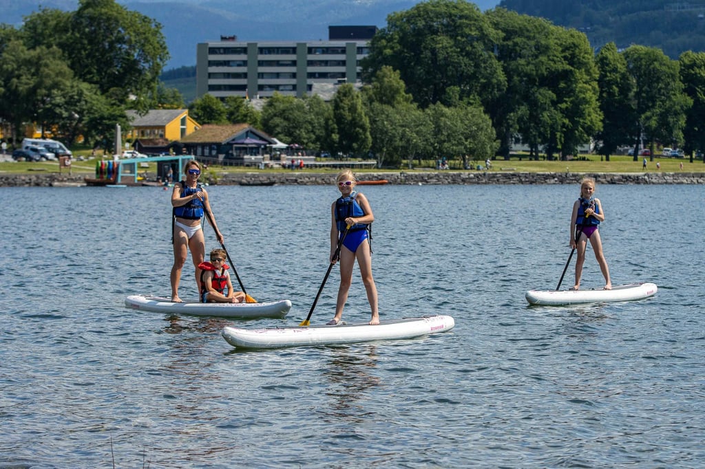 Women paddleboarding on lake - 1