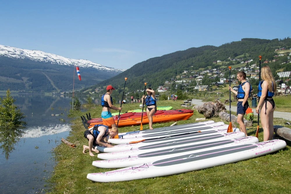 Preparing paddleboards by lake